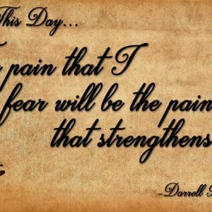Inspirational quote about pain and strength on aged paper.