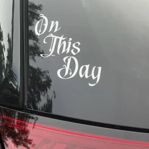 A car window decal that says 'On This Day'.