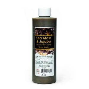 A bottle of raw Marron Jojoba oil with a white cap and label.